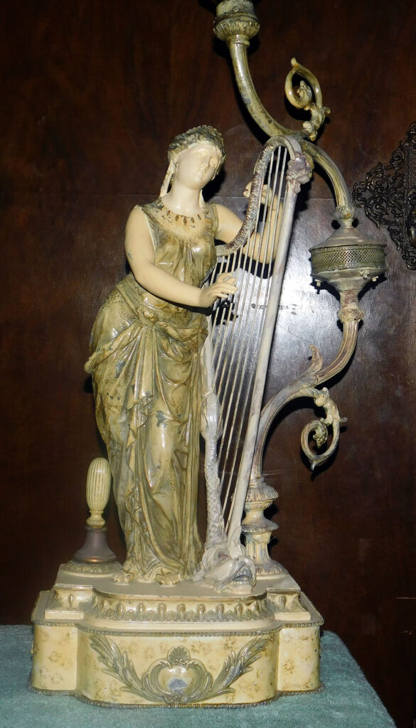 Antique Lady playing Fish Head Harp